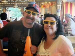 A man and woman wearing 3d glasses at a carnival.