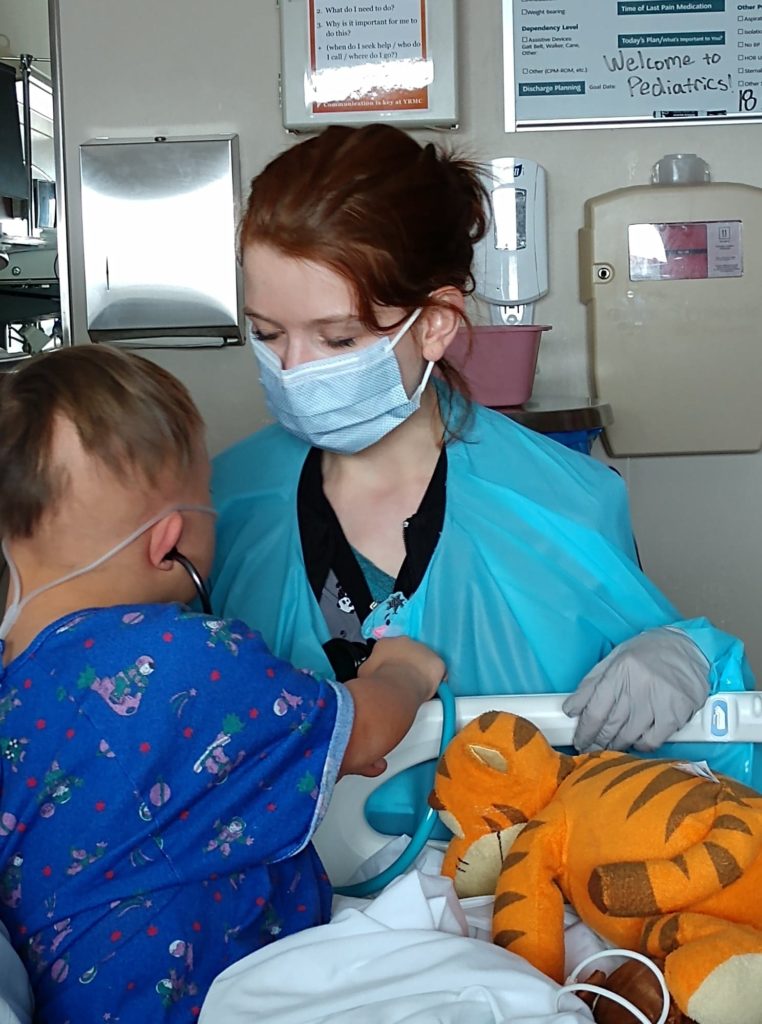 a small boy listens for the heartbeat of his nurse who brings home tot the hosptial with her stethoscope.