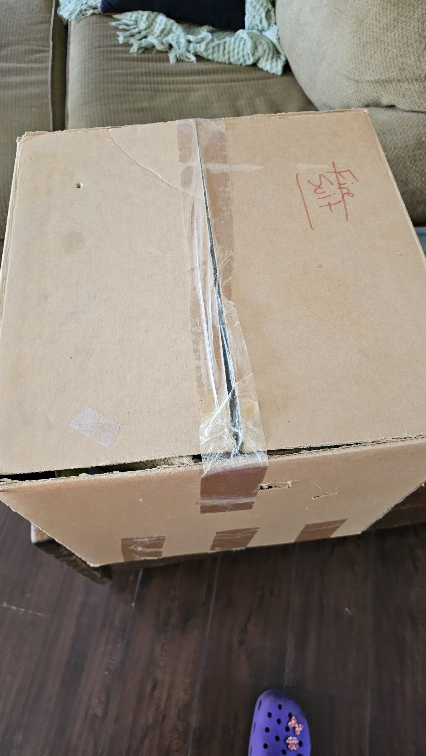 A taped cardboard box packed during a family move, symbolizing packing by faith and trusting God during an uncertain season.