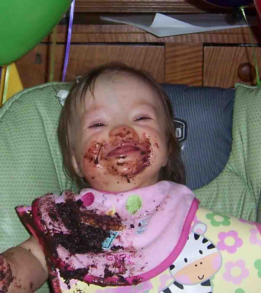 A happy baby with a messy face after eating, capturing joy, comfort, and real life in a loving family environment.
